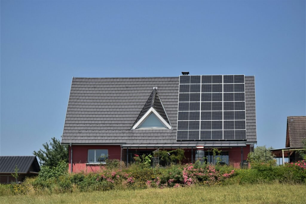 pexels-photo-17361836-17361836 A modern house with solar panels and a garden, showcasing sustainability.